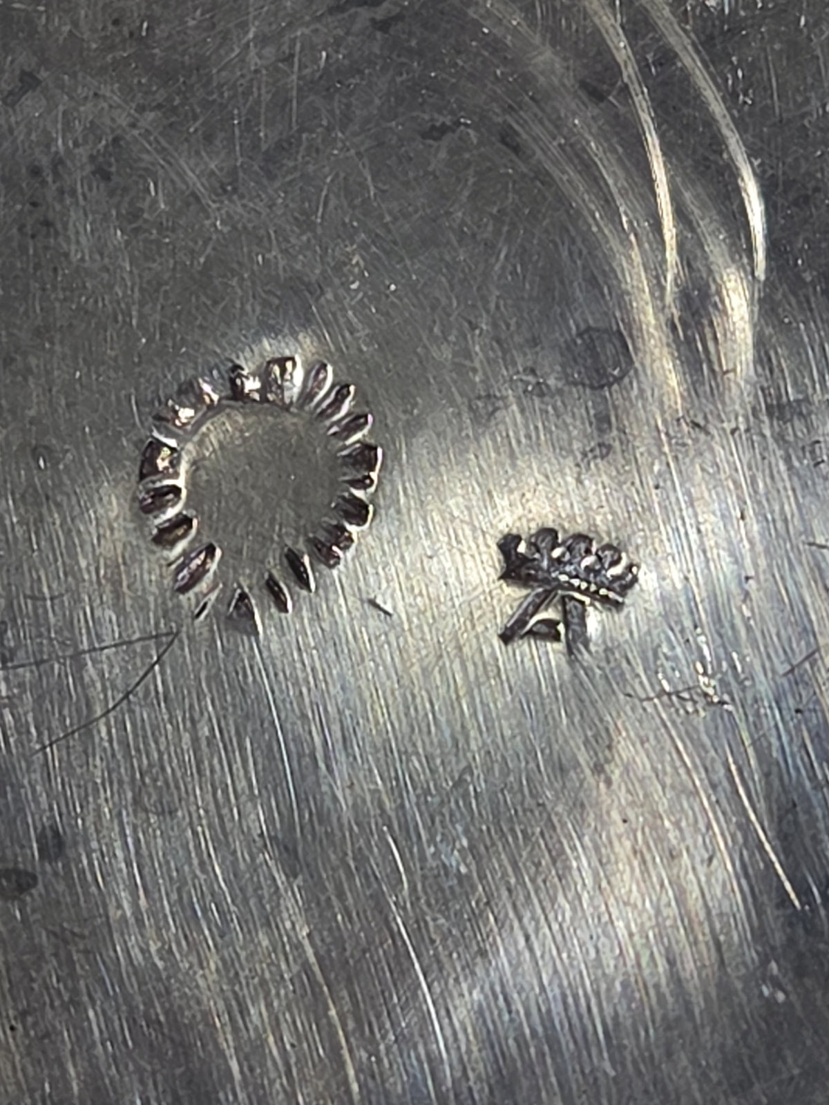 Crowned A and ring silver hallmarks on the bottom of an unidentified silver creamer