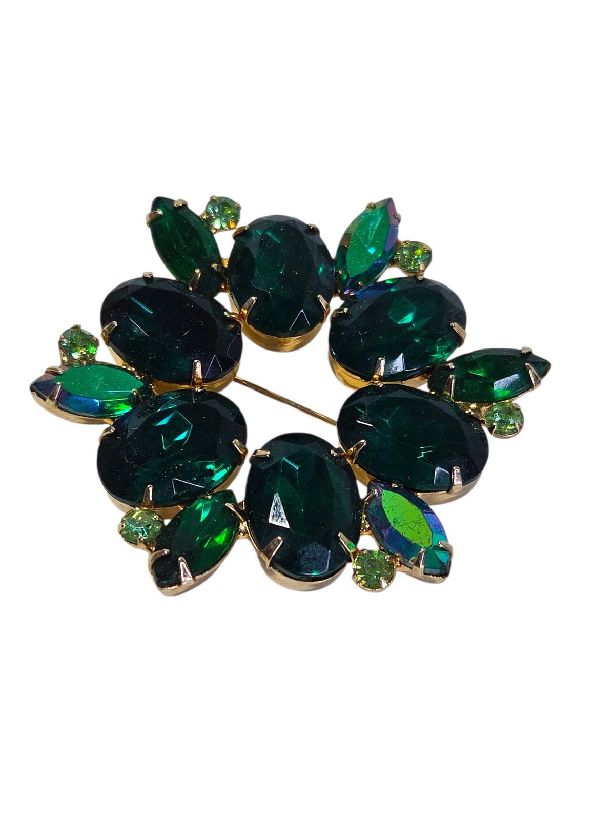 Green rhinestone wreath brooch at an angle, showing the aurora borealis navettes flashing blue and green