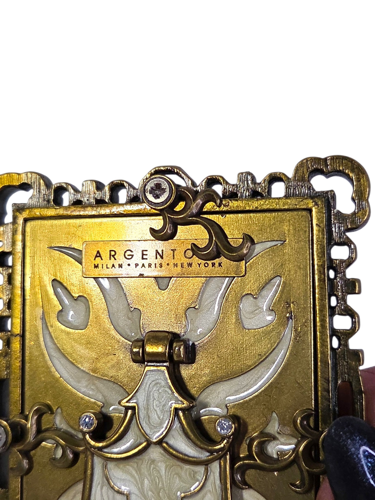 Close-up of the Argento Milan Paris New York plaque, easel hinge and turn clips on the back