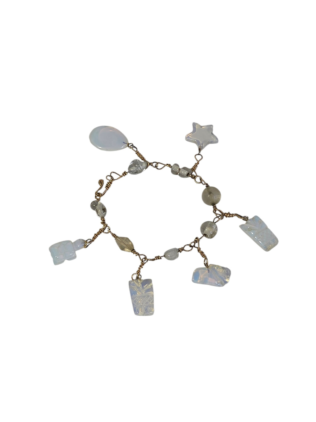 Handmade wire wrapped opalite charm bracelet on white with star, teardrop, frog, turtle and pineapple charms on gold-tone wire