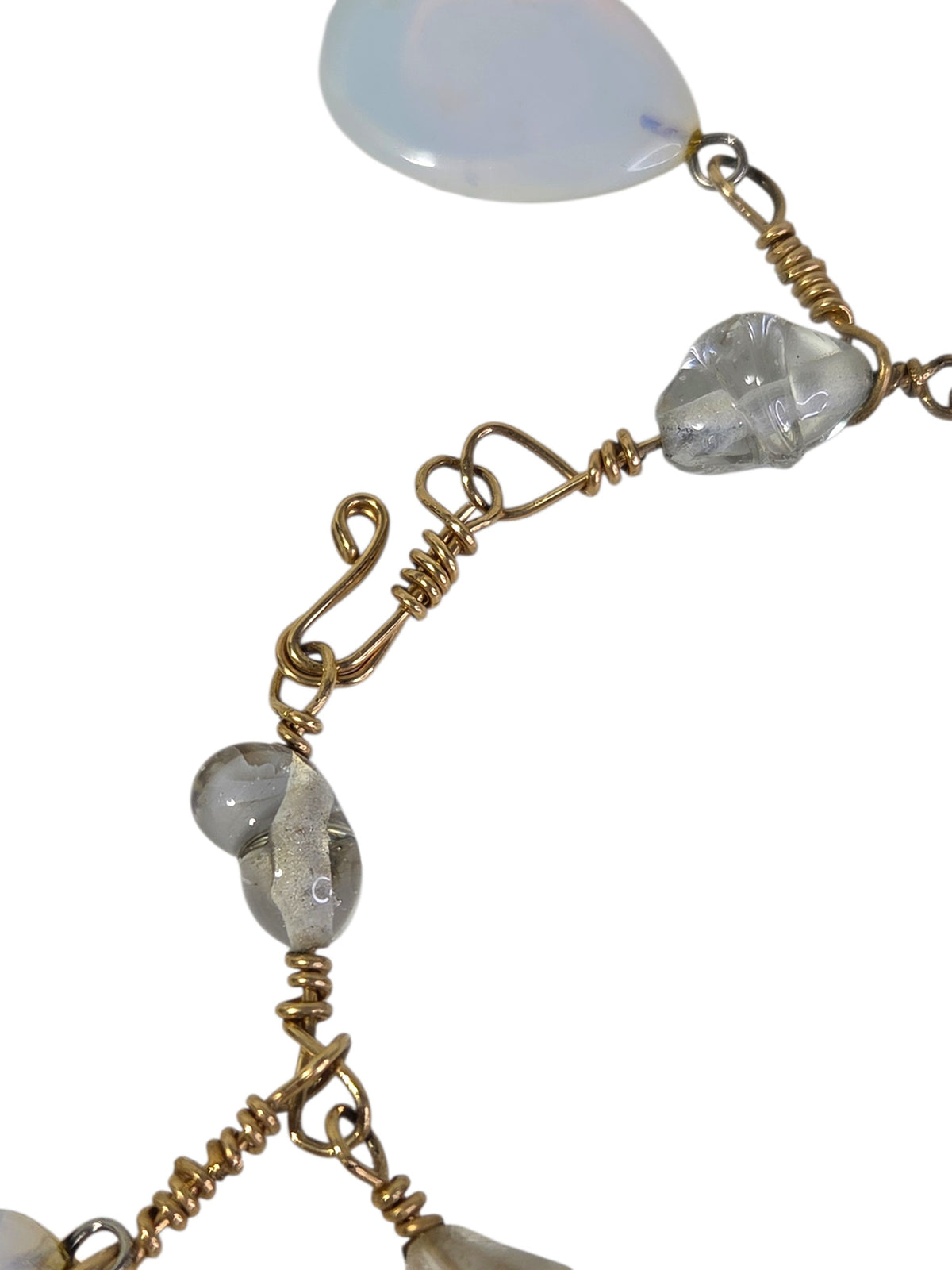 Close-up of the handmade gold-tone wire S-hook clasp and clear silver-lined glass beads