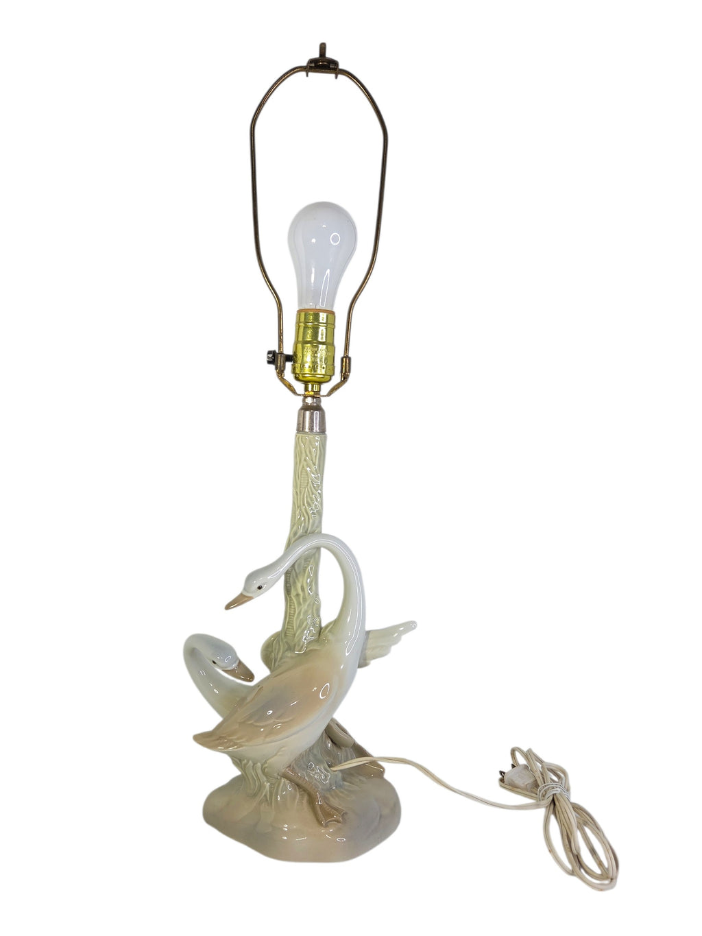 Vintage Porceval porcelain swan table lamp, two cream and blush swans around a celadon green tree trunk, close view with socket