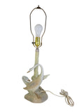 Vintage Porceval porcelain swan table lamp, two cream and blush swans around a celadon green tree trunk, close view with socket