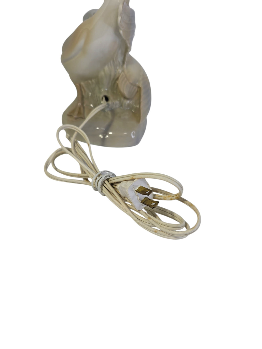 Back of the swan lamp base with the cord hole and the original yellowed cord and two-prong plug