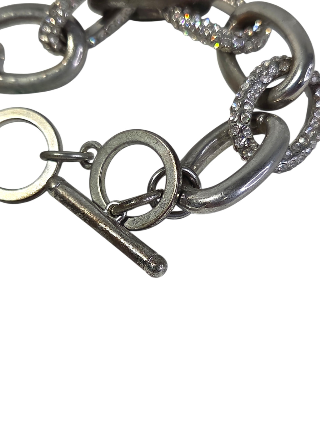 Silver-tone toggle bar and flat ring clasp on the Chico's pave link bracelet, showing wear on the bar
