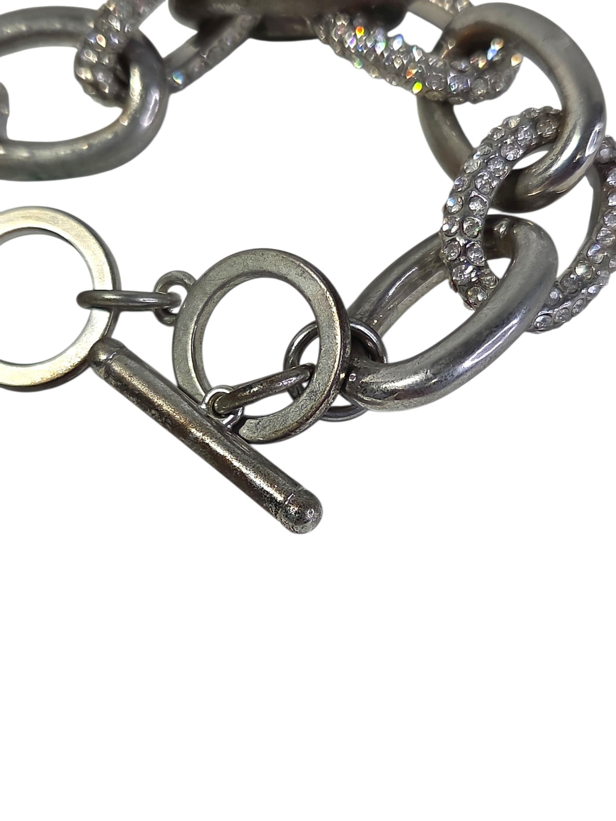 Silver-tone toggle bar and flat ring clasp on the Chico's pave link bracelet, showing wear on the bar