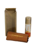 Vintage Faberge Woodhue 1/4 dram perfume bottle beside its tan leather Fabergette sleeve and clear gold-lined box