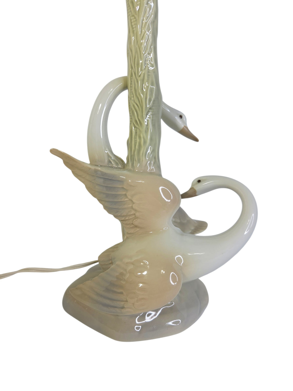 Close-up of the swans' spread wings in blush and dove gray with sculpted feathers