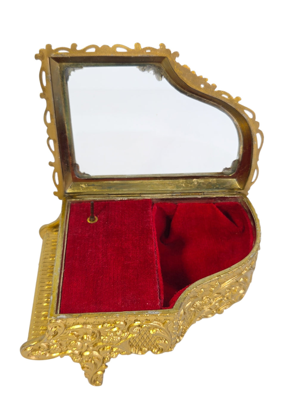 Angled view of the piano jewelry box showing the keyboard, glass lid and red velvet inside