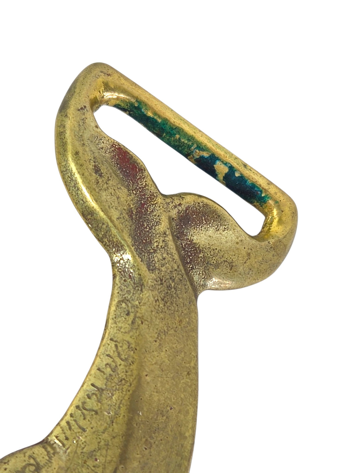 Close-up of the dolphin buckle's tail loop with green verdigris on the inside edge
