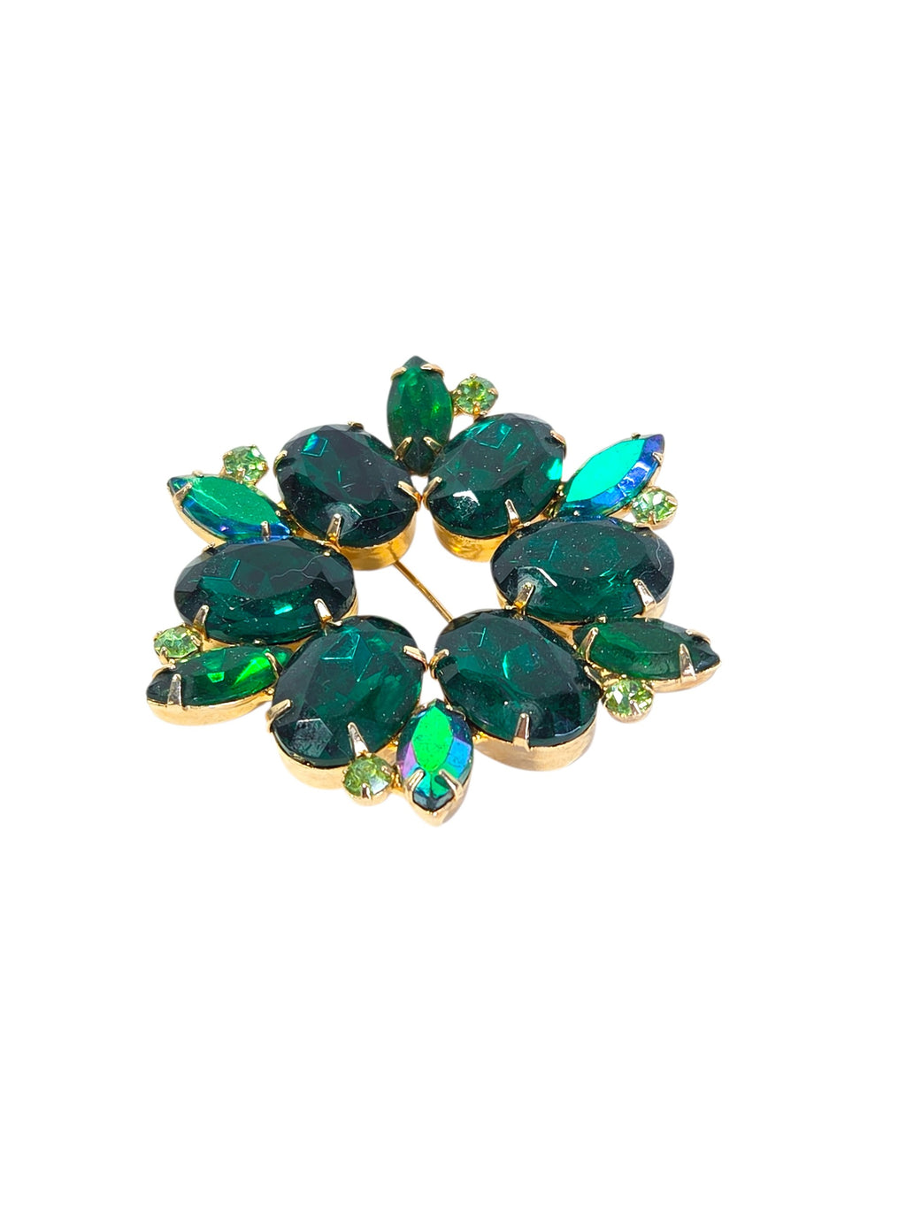 Emerald green rhinestone wreath brooch held in hand to show its 2 1/2 inch size