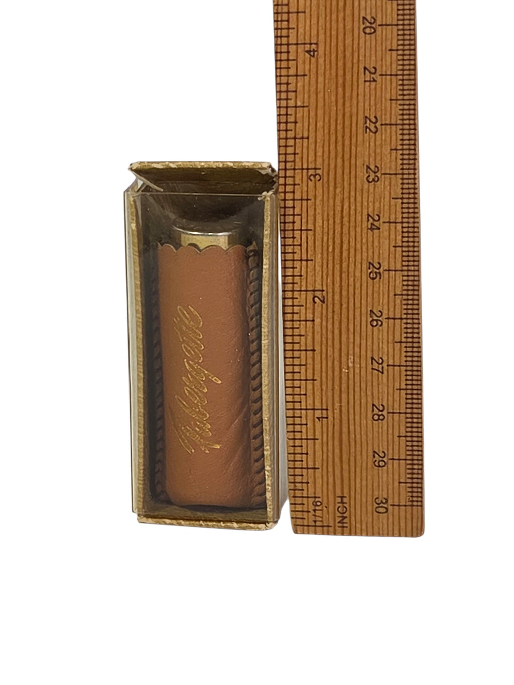 Front of the clear box showing the tan leather sleeve stamped Fabergette in gold