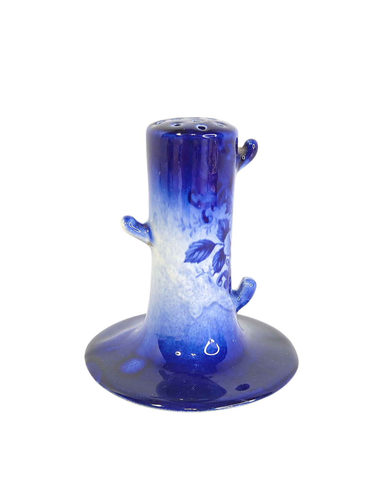 Blue and white tree stump hatpin holder from above, showing the pierced holes on top for hatpins