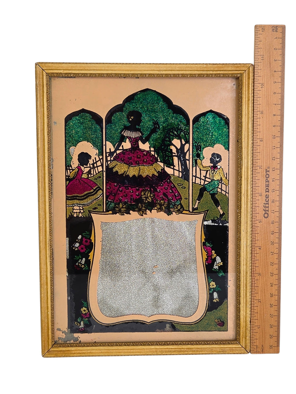 Tinsel art silhouette picture beside a ruler, about 10 inches tall