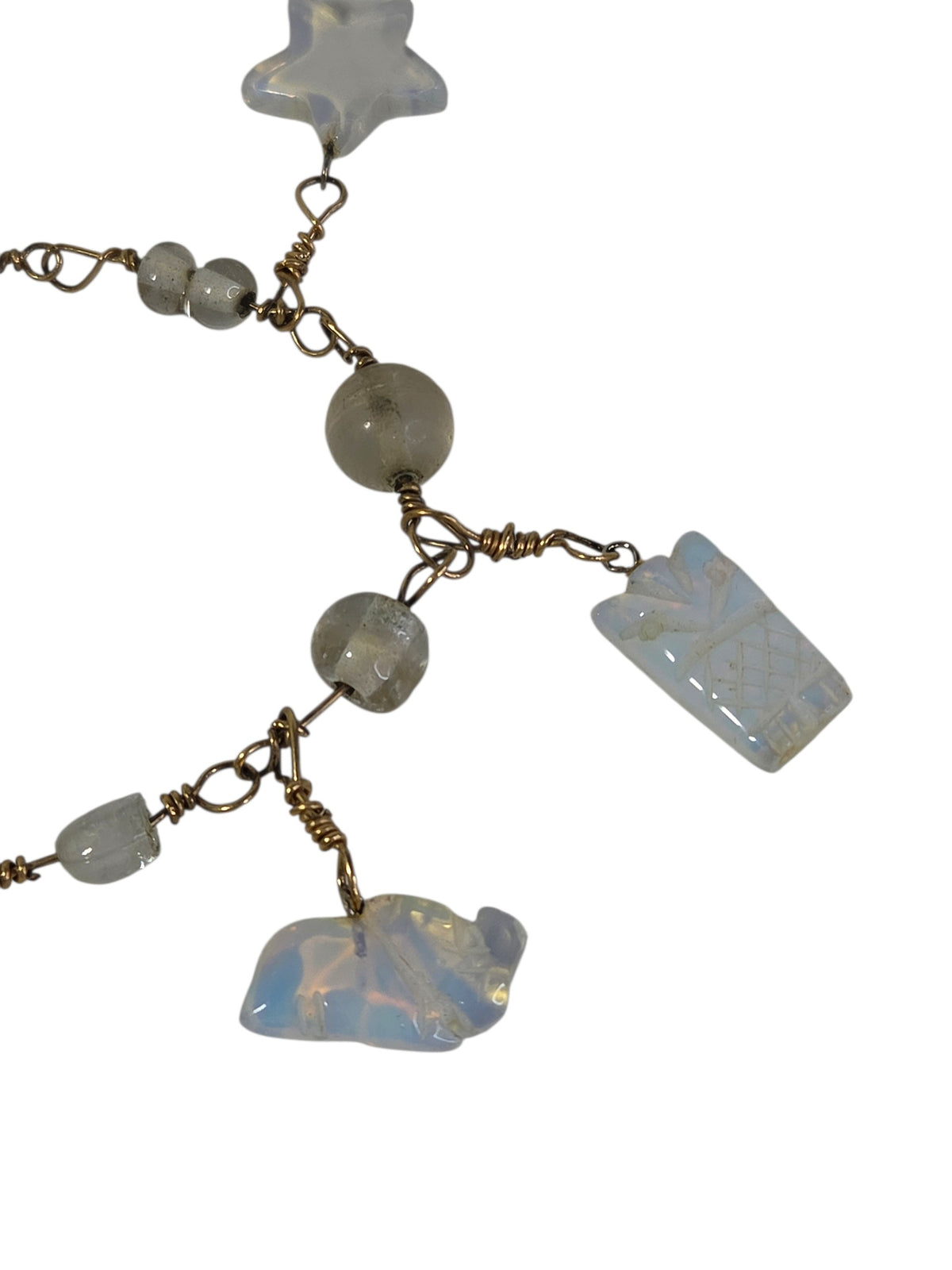 Close-up of the opalite star, pineapple and frog charms with smoky glass beads and hand-coiled wire wraps