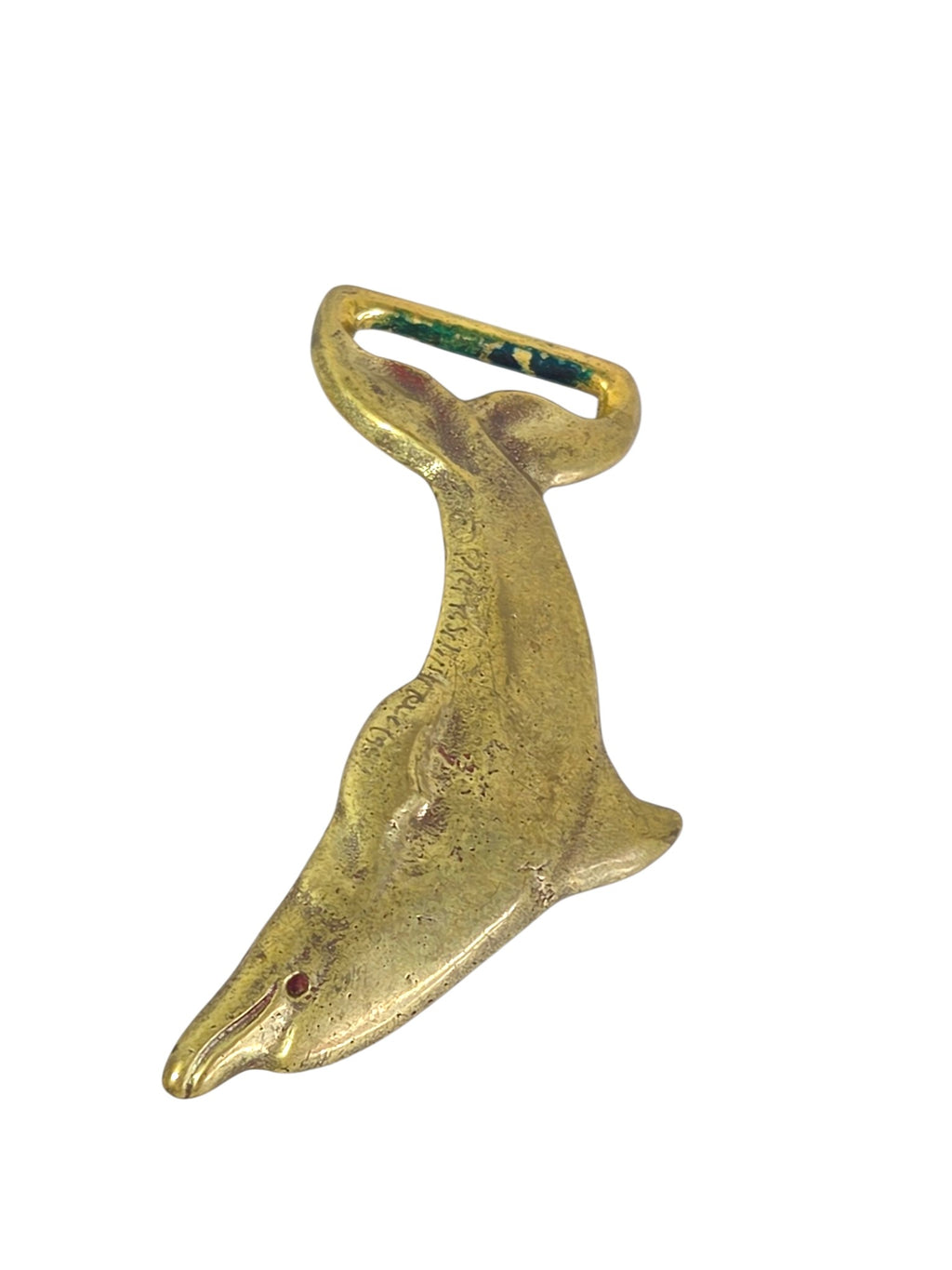 Back of the brass dolphin belt buckle, textured as cast, with the belt stud near the head