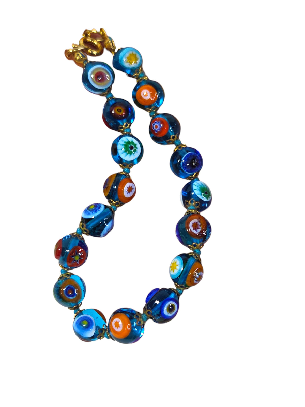 Millefiori bead bracelet hanging, showing orange, green, yellow and blue flower canes in aqua glass