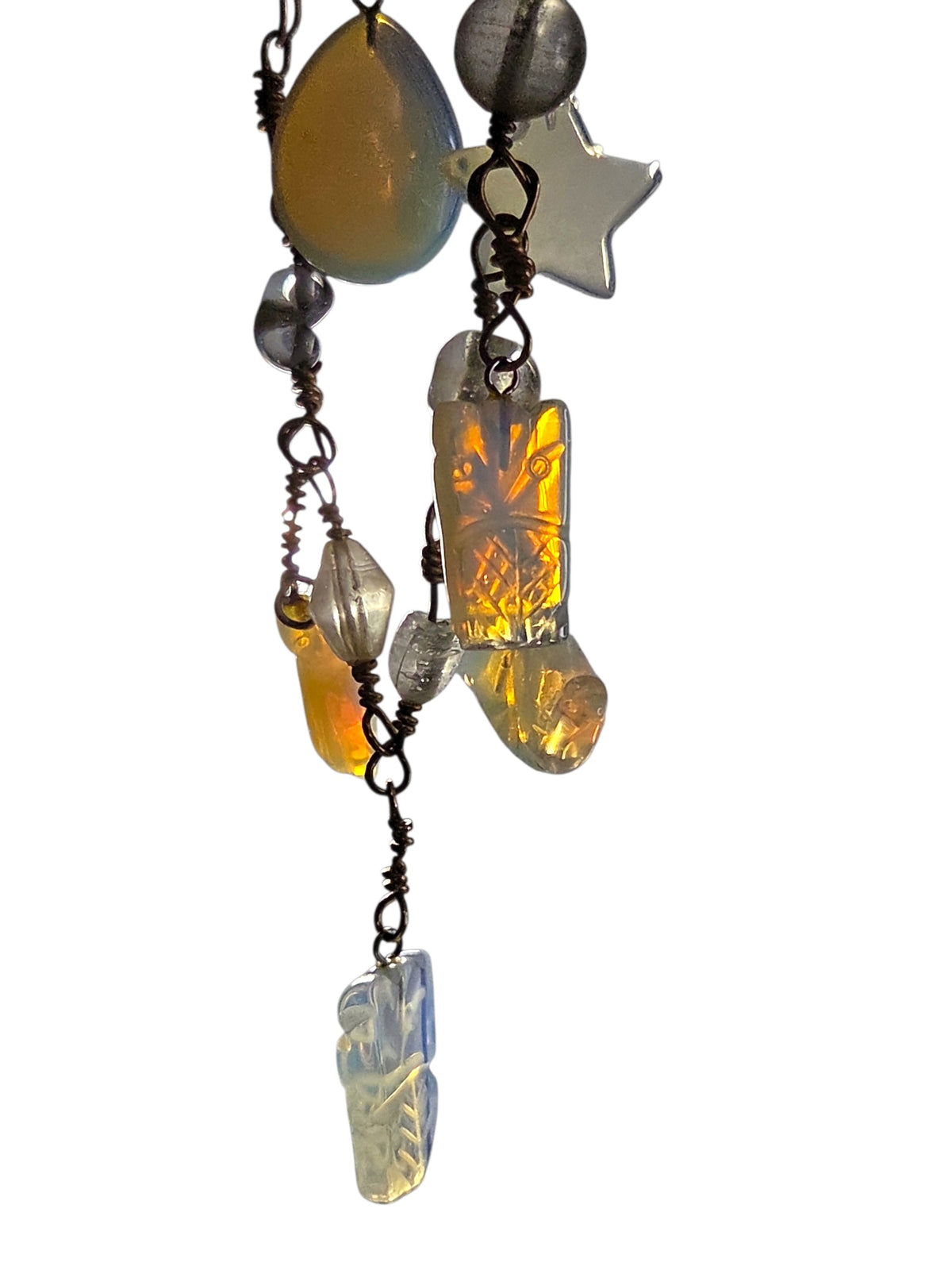 Detail of the hand-wrapped gold-tone wire links and opalite charms on the bracelet