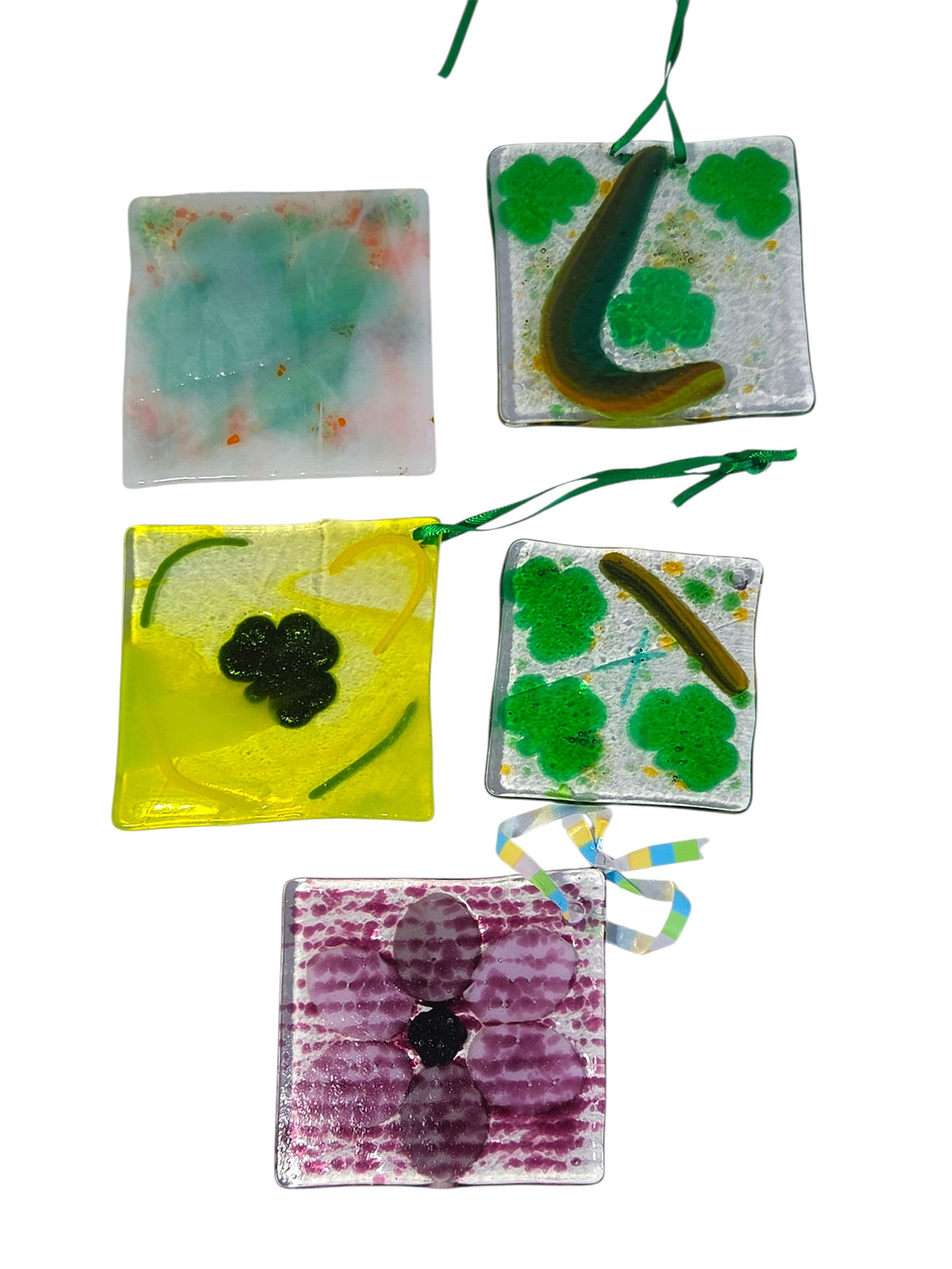 Backs of the five fused glass suncatcher ornaments, smooth glass with colors showing through