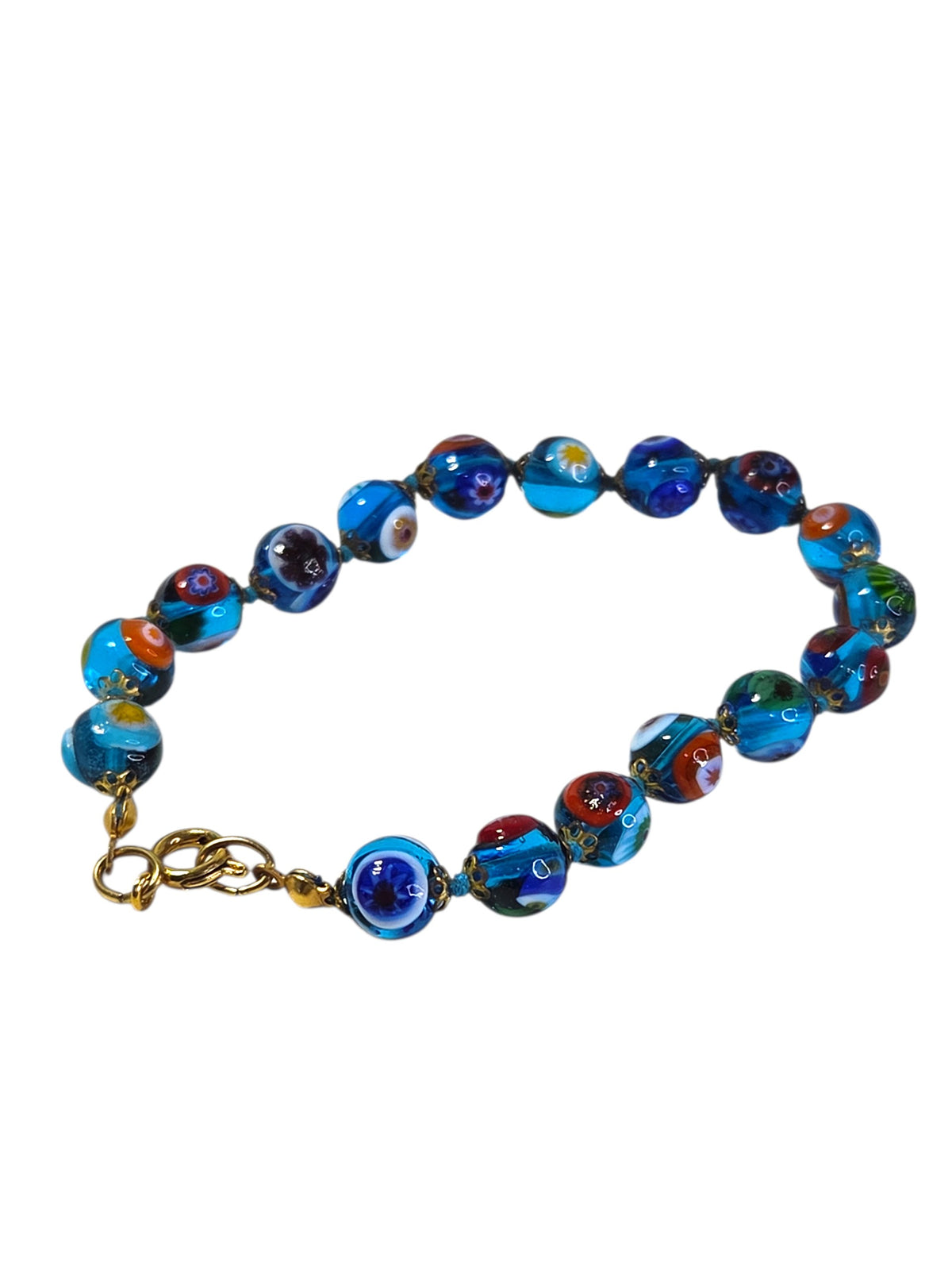 Detail of the hand-knotted aqua thread between the millefiori glass beads and gold-tone caps