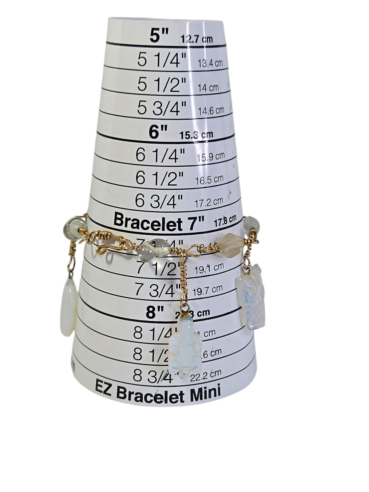 Opalite charm bracelet on a bracelet sizing cone, fitting about 7 1/4 inches