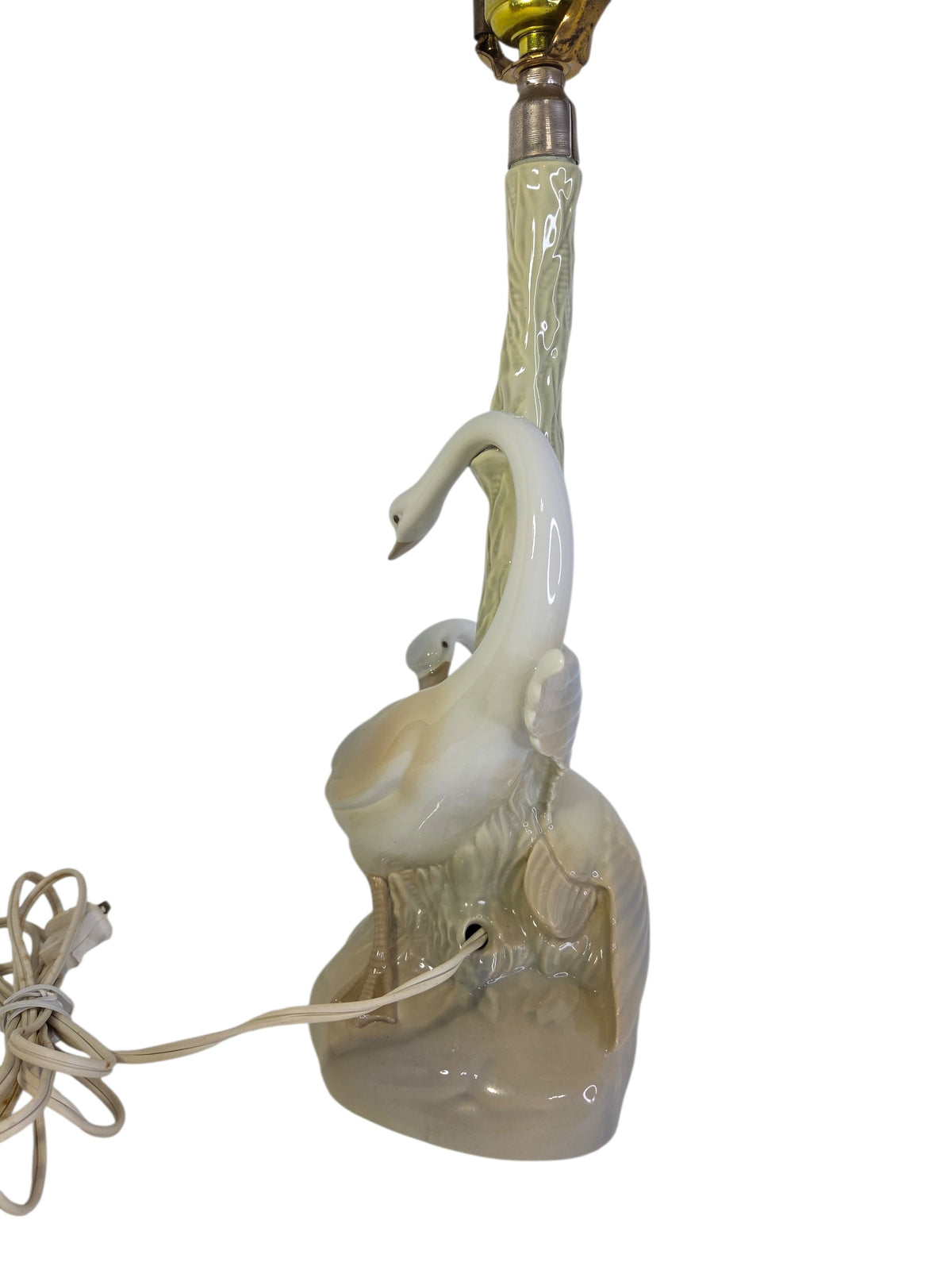 Side view of the Porceval swan lamp showing the turn-key switch on the brass socket