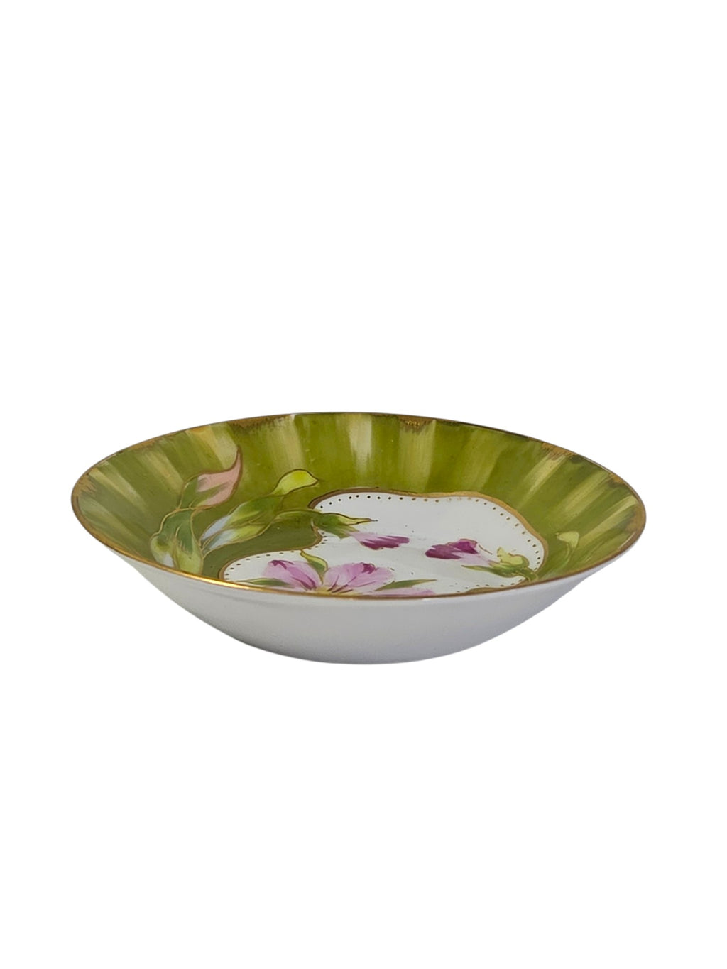 Side view of the small porcelain dish showing its depth and gilded rim