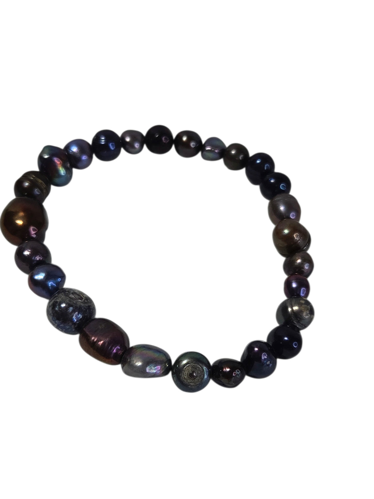 Dark freshwater pearl bracelet laid in an oval, showing the large bronze statement pearls
