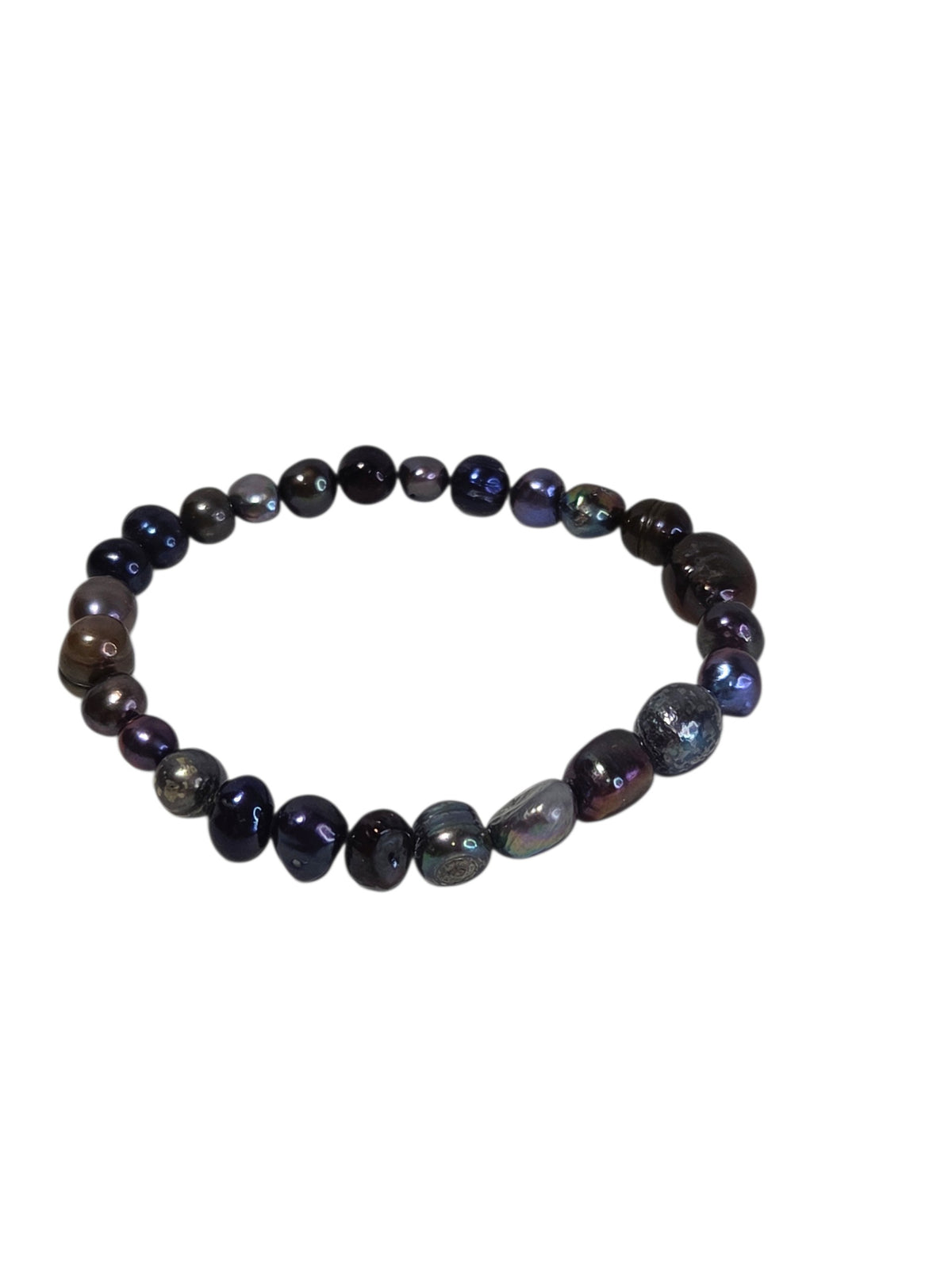 Freshwater pearl stretch bracelet showing rainbow overtones on the dark baroque and ringed pearls