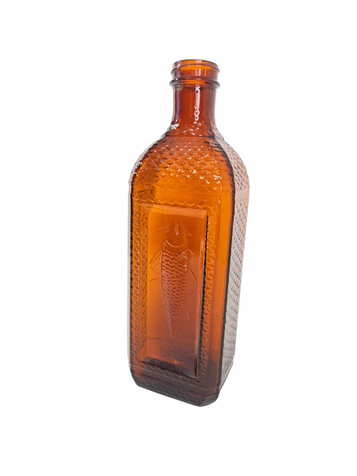 Oddly Darling Vintage amber glass bottle featuring an embossed fish design and textured scale pattern on the sides.