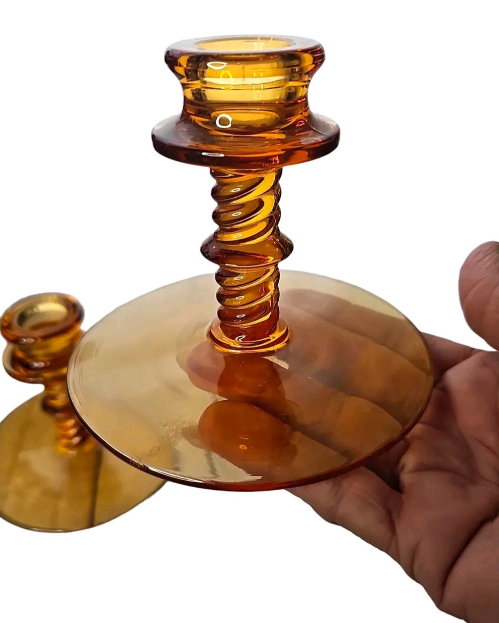 Oddly Darling Vintage set of two amber glass candlestick holders featuring elegant twisted stems and wide stable bases.