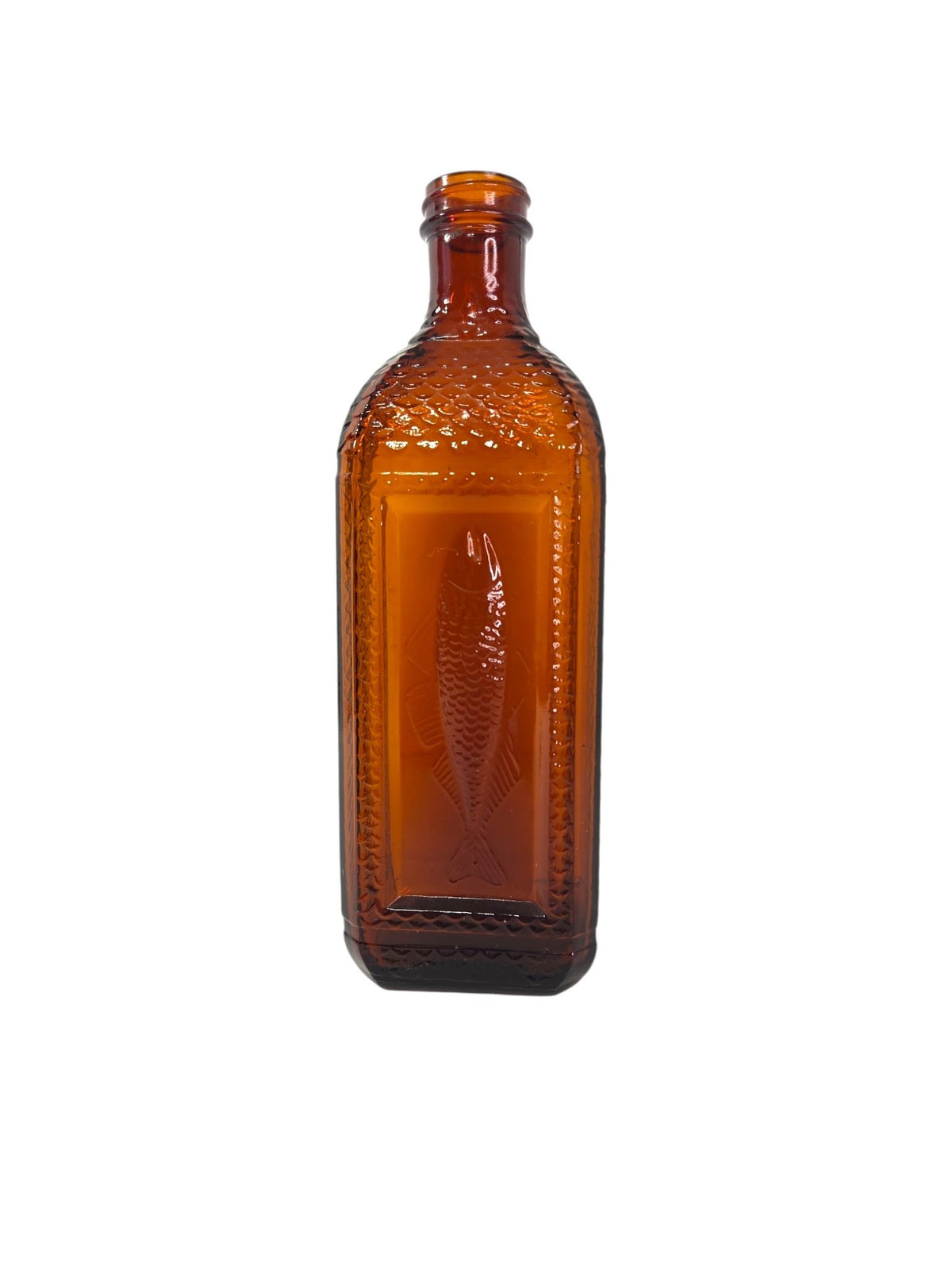 Vintage amber glass cod liver oil bottle with an embossed fish and fish scale pattern