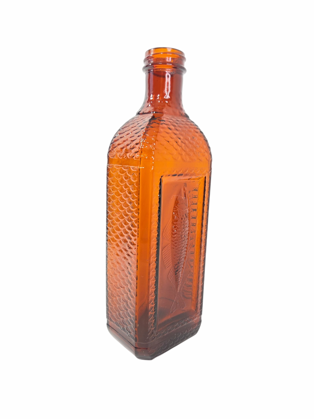 Oddly Darling Vintage amber glass bottle featuring an embossed fish motif and textured scale pattern on the sides.