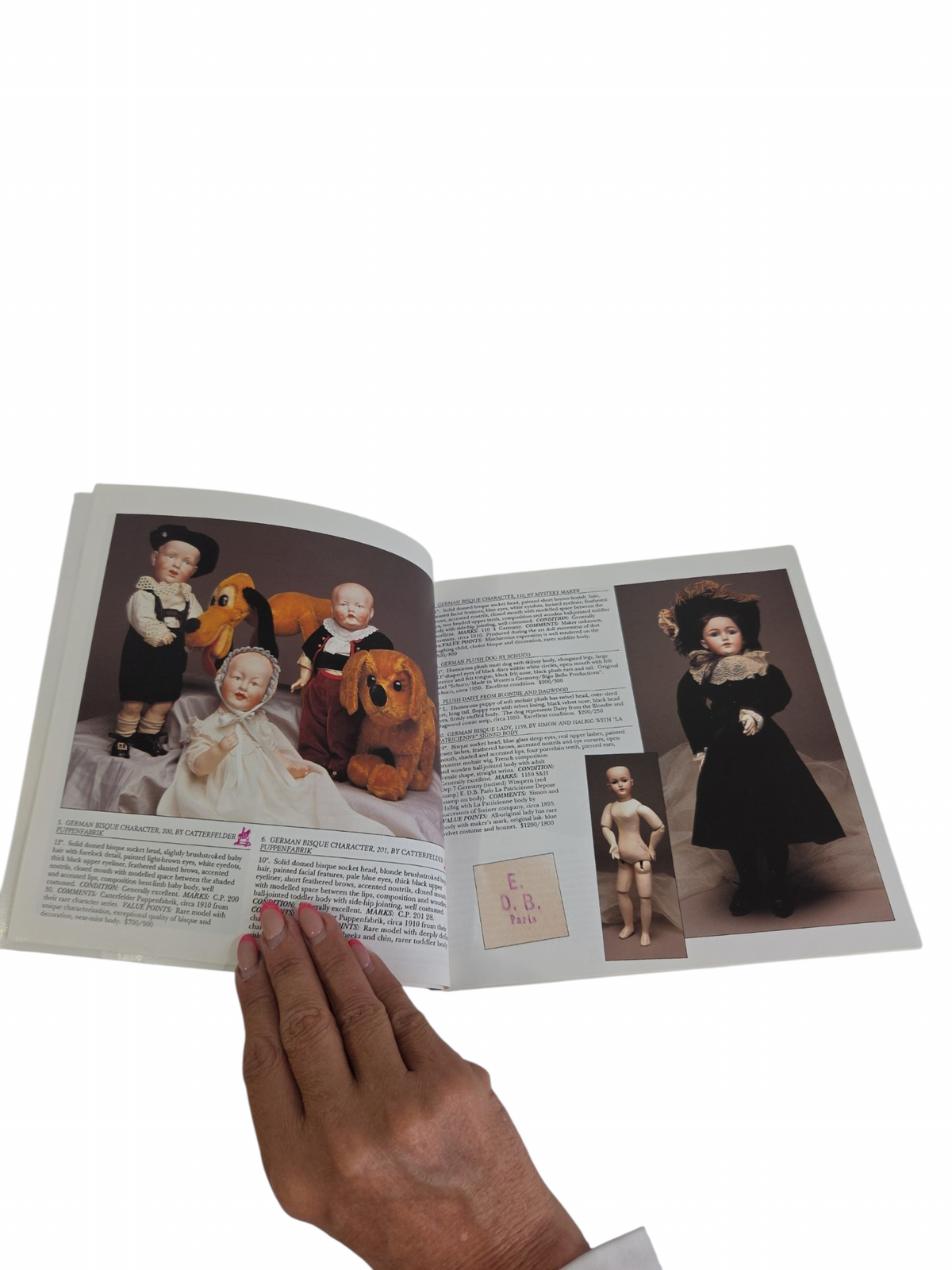Oddly Darling Vintage Theriault's antique doll auction catalogue open to pages showing German and French bisque dolls.