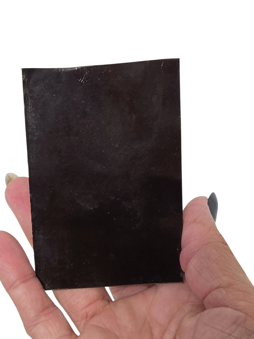 Oddly Darling Vintage antique tintype photograph on a metallic base held in a hand