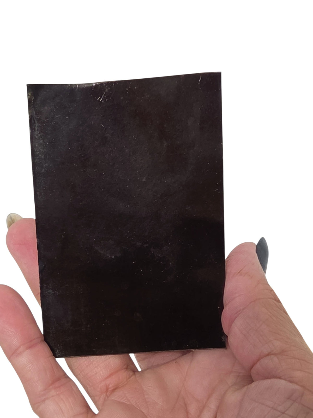 Oddly Darling Vintage antique tintype photograph on a metallic base held in a hand