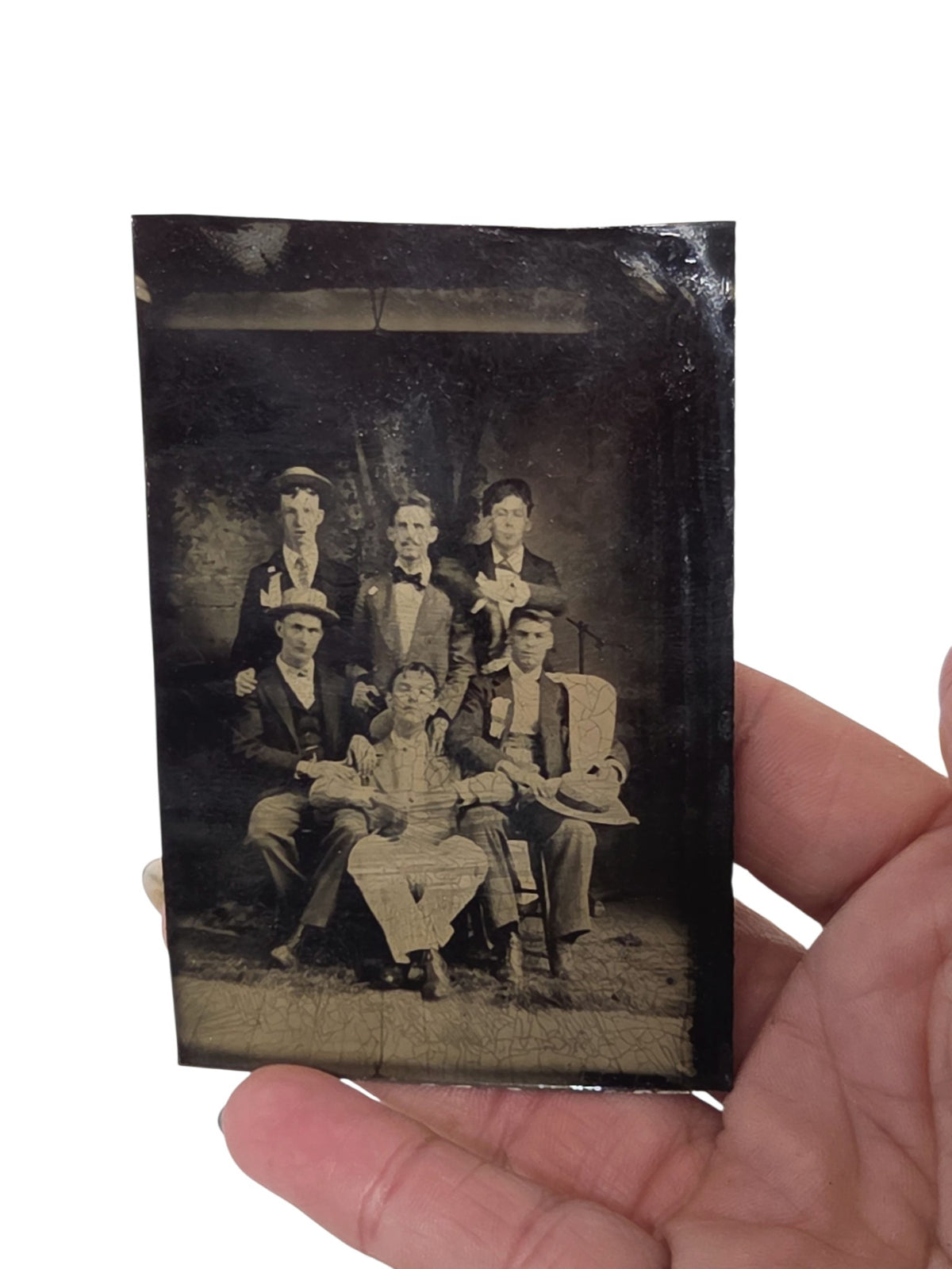 Oddly Darling Vintage antique tintype photograph of six men in 19th-century formal attire held in a hand