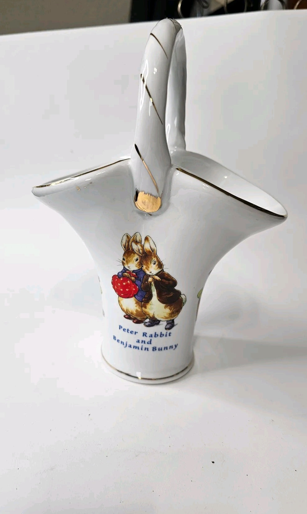 Oddly Darling Vintage white porcelain basket vase featuring Peter Rabbit and Benjamin Bunny with gold-tone trim.