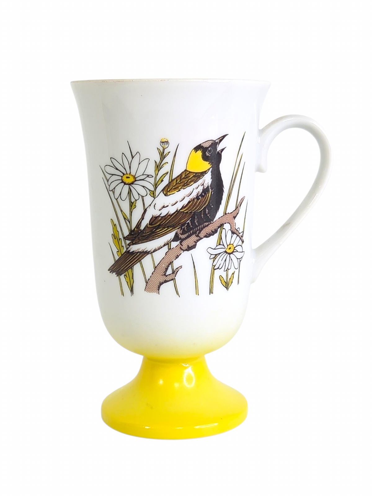 Oddly Darling Vintage white ceramic pedestal mug featuring a songbird and daisy illustration with a yellow base.