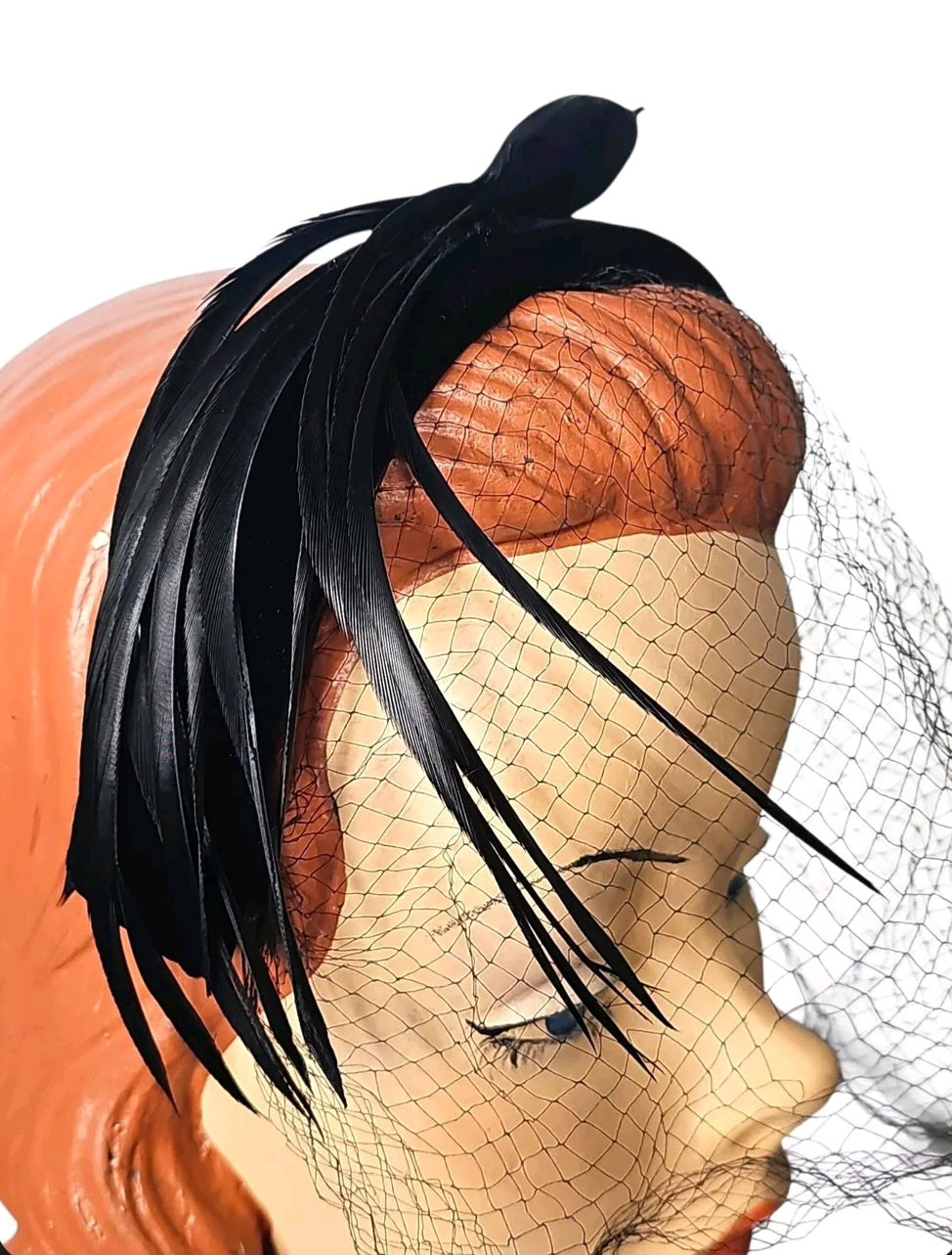 Oddly Darling Vintage black velvet fascinator headband featuring sleek feathers and a delicate mesh veil on a mannequin.