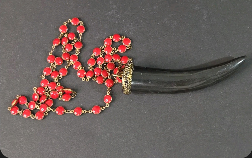 Oddly Darling Vintage long necklace with a black tusk pendant, gold-tone cap, and vibrant red circular enamel beads.
