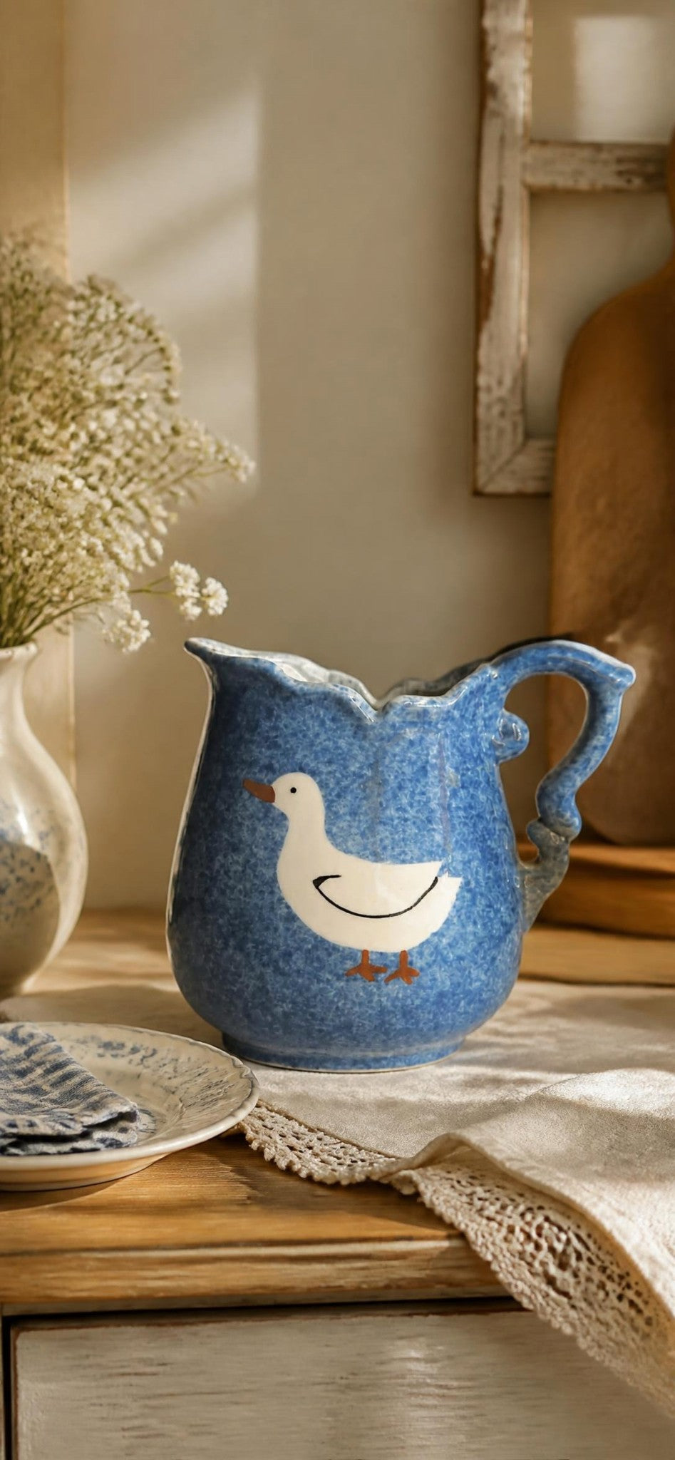 Oddly Darling Vintage ceramic pitcher with blue sponge-ware glaze, scalloped rim, and hand-painted duck motif.
