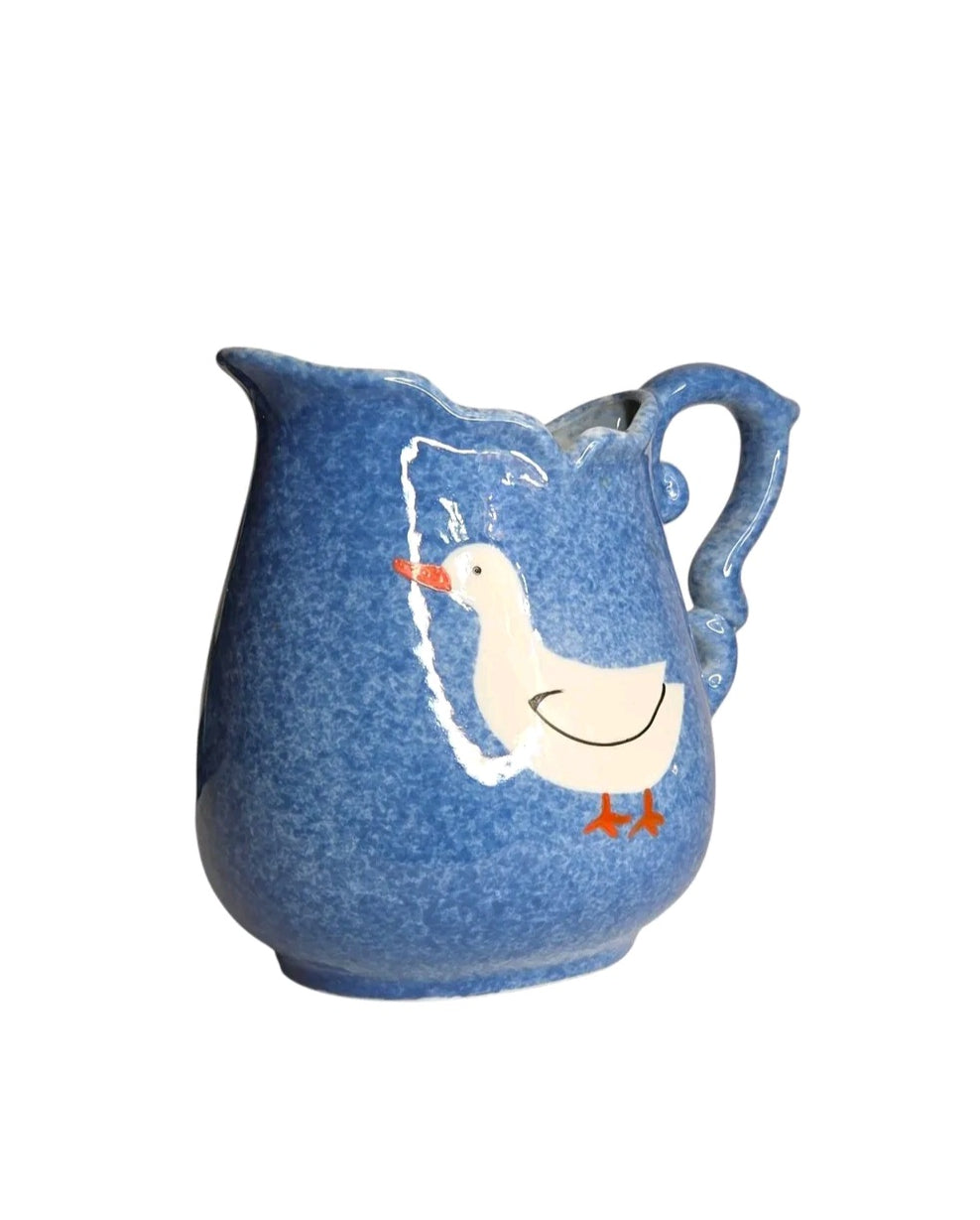 Oddly Darling Vintage ceramic pitcher with mottled blue glaze, scalloped rim, and a hand-painted duck motif.