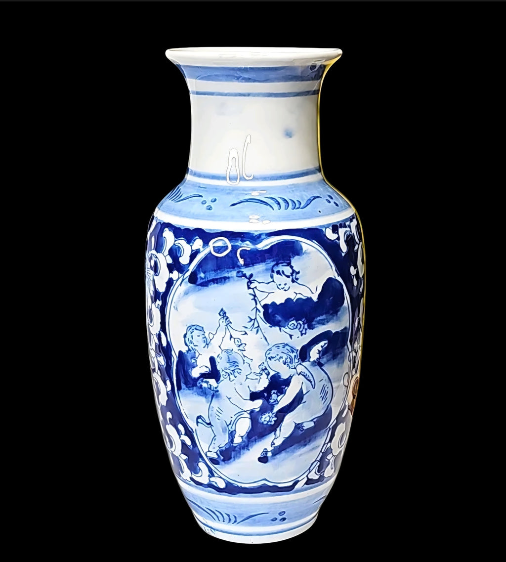 Oddly Darling Vintage blue and white ceramic vase featuring hand-painted cherub motifs and intricate floral scrollwork.