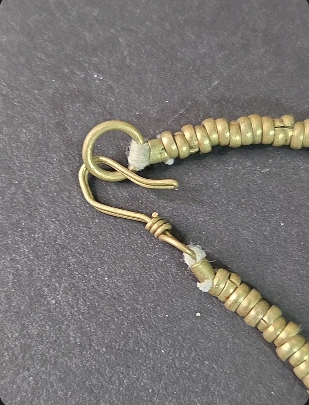 Oddly Darling Vintage bohemian necklace featuring a secure metallic hook-and-eye clasp and textured brass-tone beads.