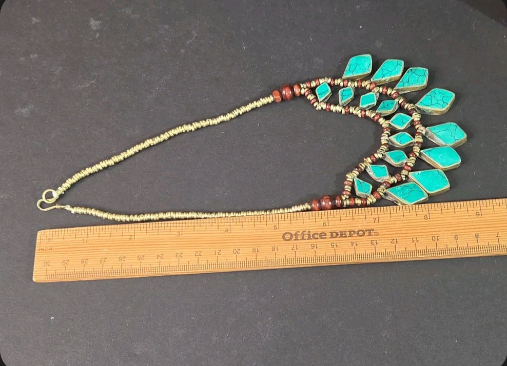 Oddly Darling Vintage bohemian statement necklace with turquoise stones, wooden beads, and metallic accents on a ruler.
