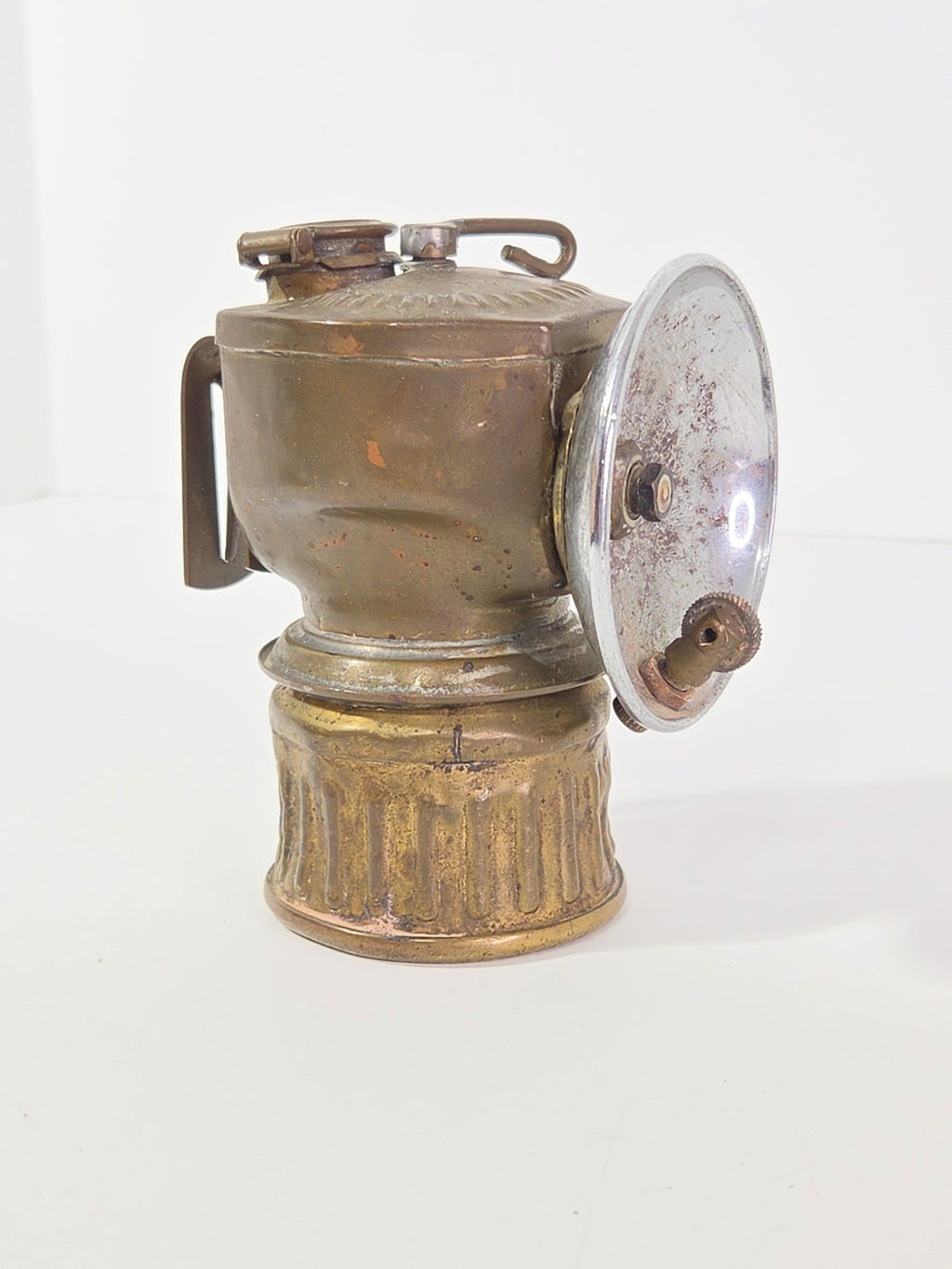 Oddly Darling Vintage antique brass carbide miner lamp with a weathered patina and reflective chrome-plated dish.