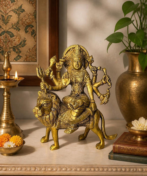 Oddly Darling Vintage handcrafted brass Goddess Durga statue riding a lion with intricate carvings and gold finish.