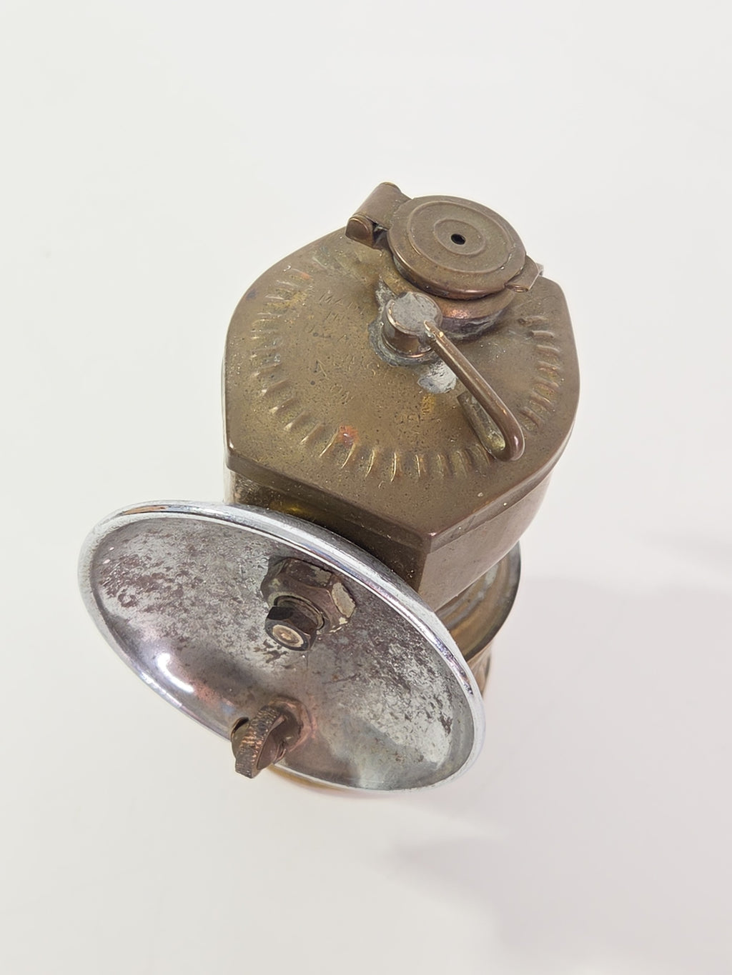 Oddly Darling Vintage antique brass miner carbide lamp with a weathered patina and chrome-plated reflective dish.