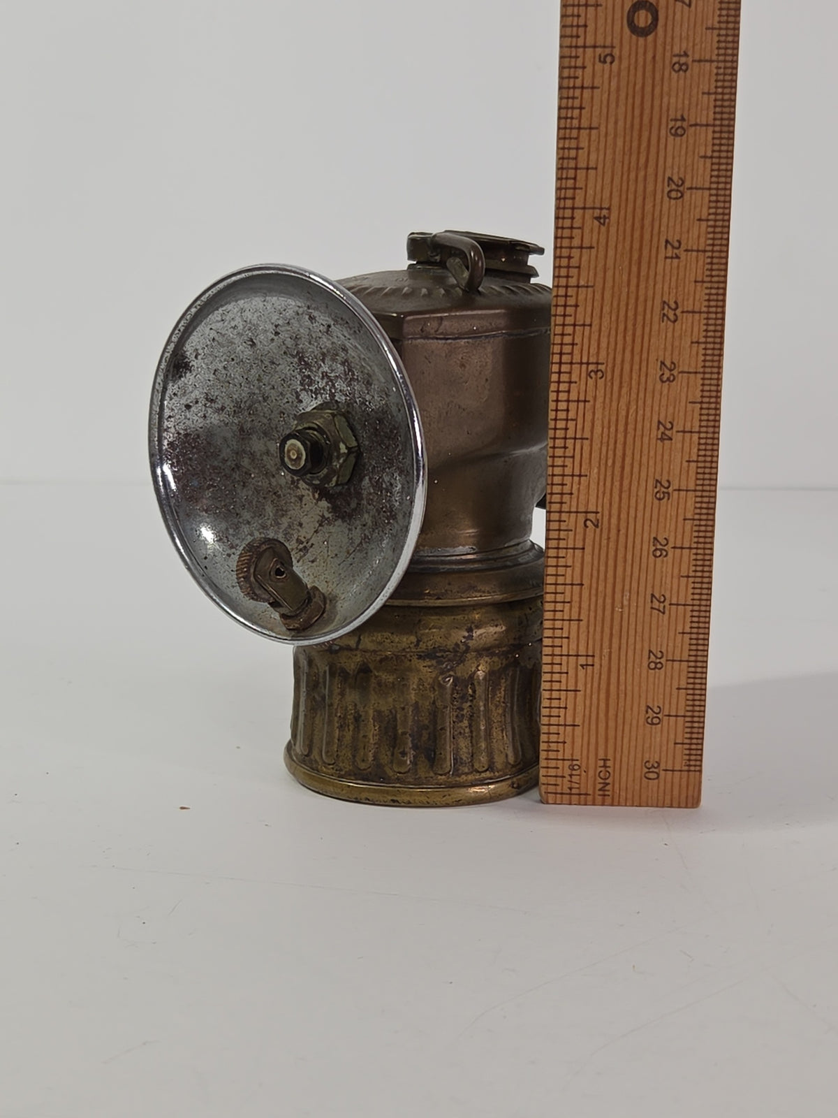 Oddly Darling Vintage antique brass miner carbide lamp with a chrome reflector dish and weathered patina.